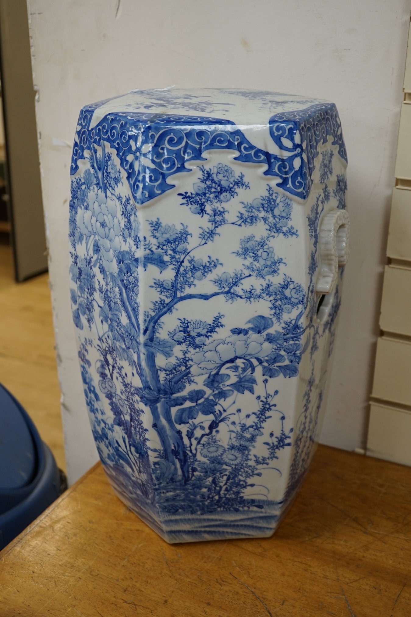 An early 20th century Japanese hexagonal blue and white porcelain garden seat, 50cm high. Condition- fair, has hairline crack